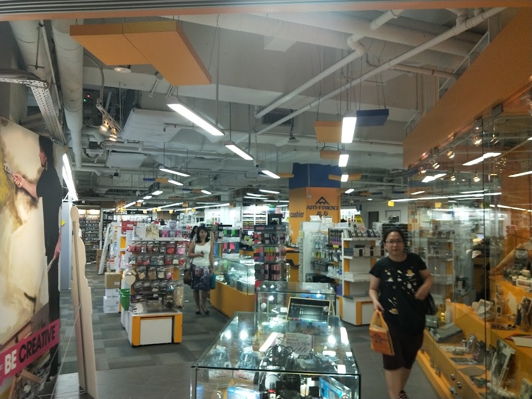 An interior view of Art Friend, an art supply store, showcasing aisles of products and customers browsing.