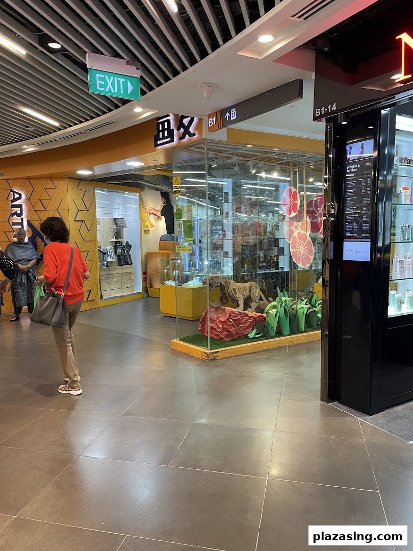 The entrance of Art Friend, an art supply store, featuring a display case with a tiger sculpture.