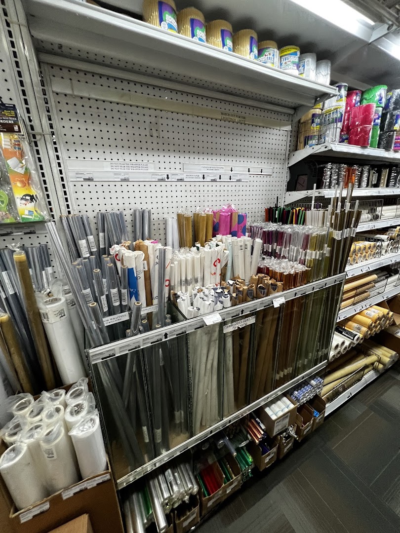 Shelves at Art Friend stocked with a wide variety of art and craft paper rolls and supplies.