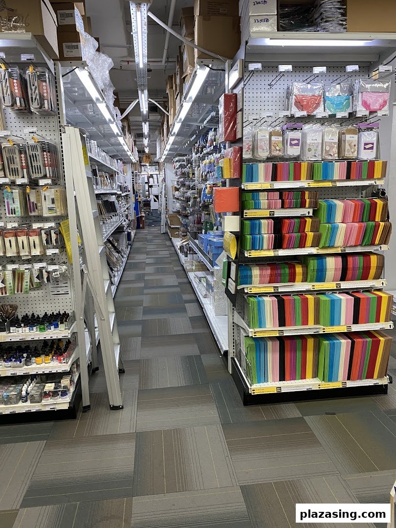 A long aisle inside an art supply store, showcasing a wide array of colorful art and craft materials.