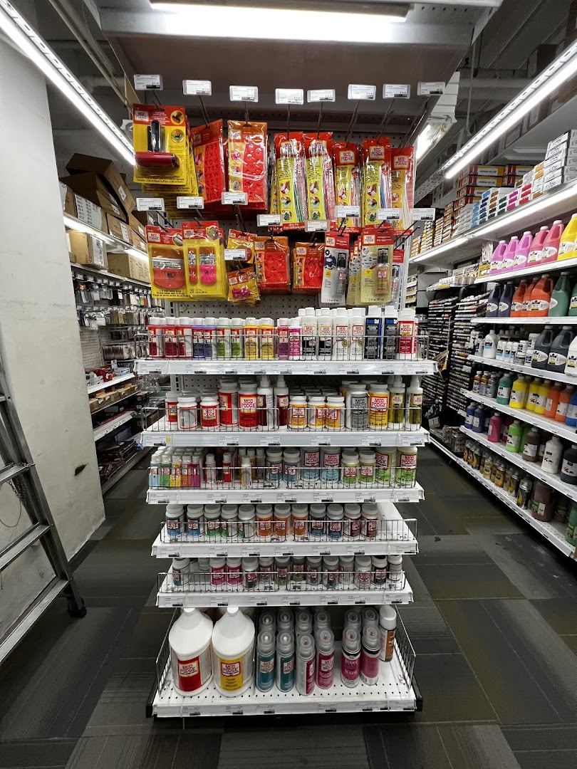 An aisle in Art Friend showcasing a wide array of Mod Podge products, paints, and various art and craft supplies.