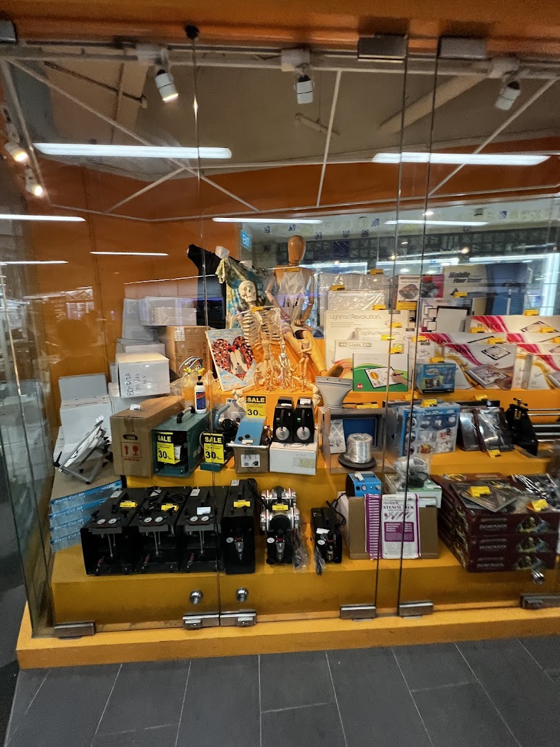 A vibrant display window at Art Friend showcasing a diverse range of art and craft supplies, including models and tools.