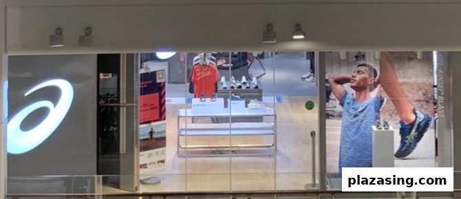 The ASICS shop front features athletic footwear, apparel, and large promotional displays.