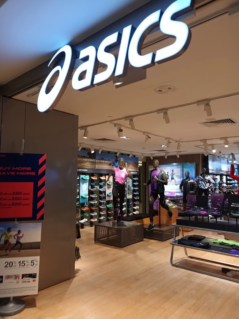 Interior view of the ASICS store showcasing athletic footwear, apparel, and mannequins.