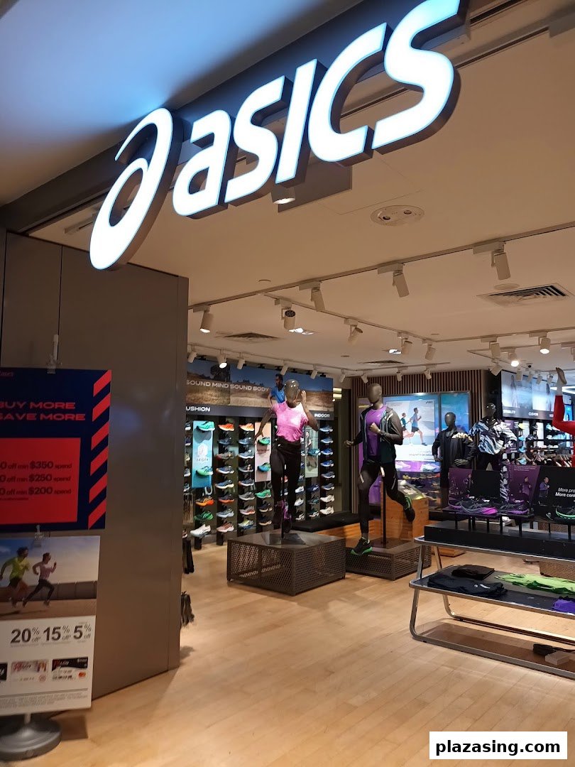 Interior view of the ASICS store showcasing athletic footwear, apparel, and mannequins.