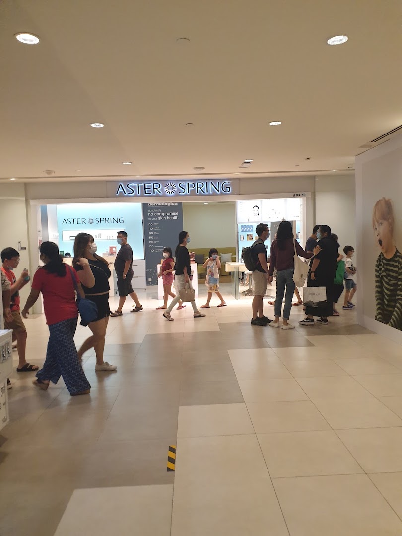 The bright entrance of AsterSpring skincare shop in a mall, with people walking past.