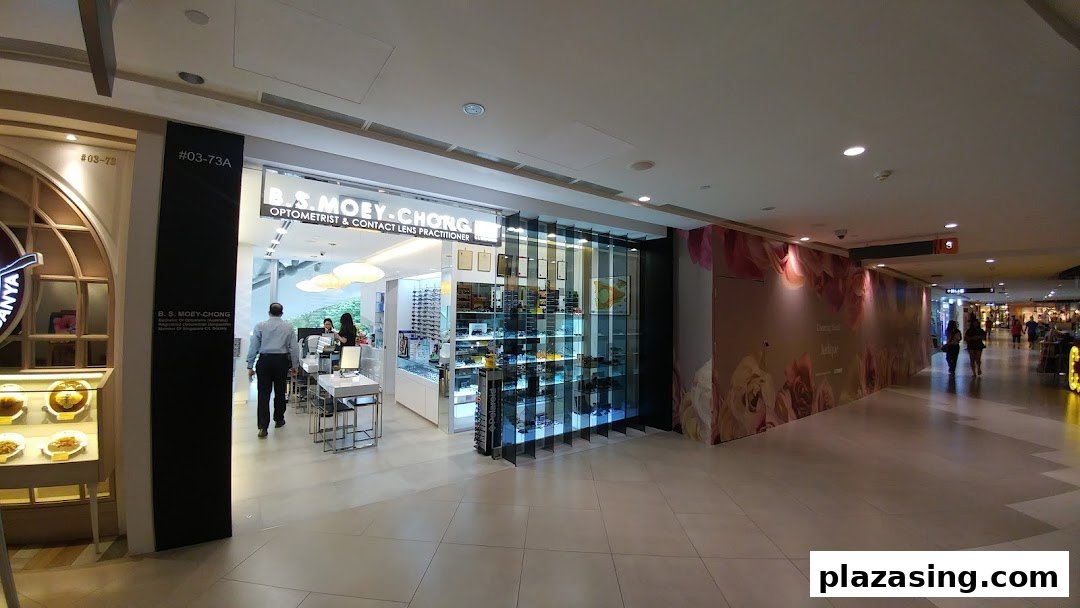 The image displays the well-lit shop front of B.S Moey-Chong Optometrist & Contact Lens Practitioner.