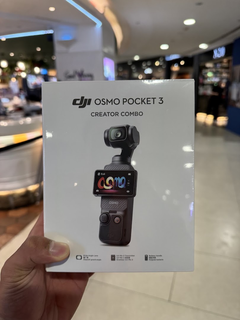 A person holds a DJI Osmo Pocket 3 Creator Combo box inside Bally Photo Electronics.