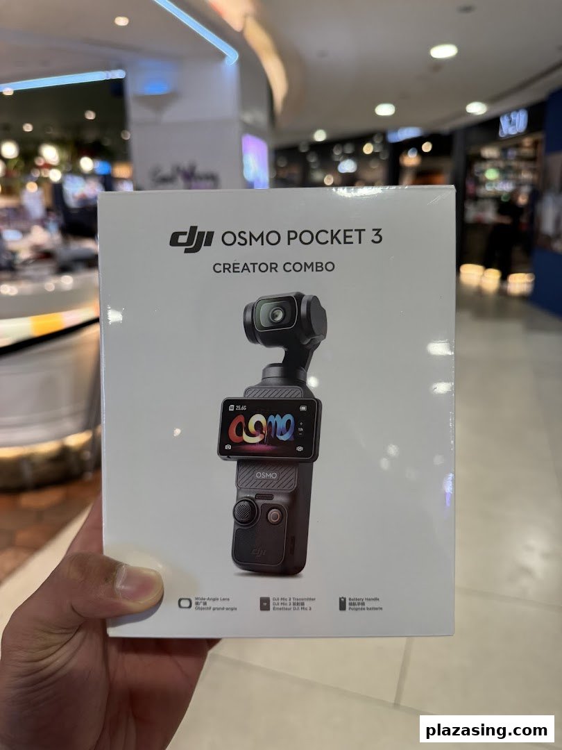 A person holds a DJI Osmo Pocket 3 Creator Combo box inside Bally Photo Electronics.