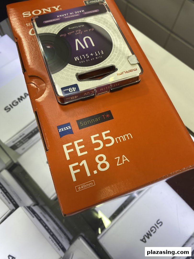 A Sony FE 55mm F1.8 ZA lens box with a Marumi UV filter package on top.