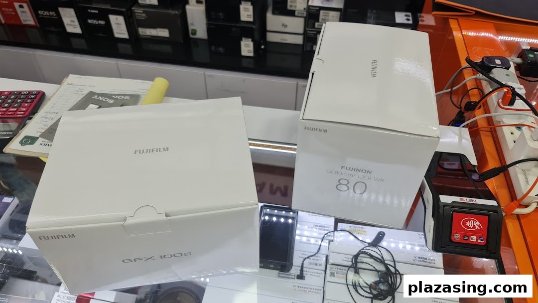 Fujifilm camera and lens boxes displayed on a counter at Bally Photo Electronics.
