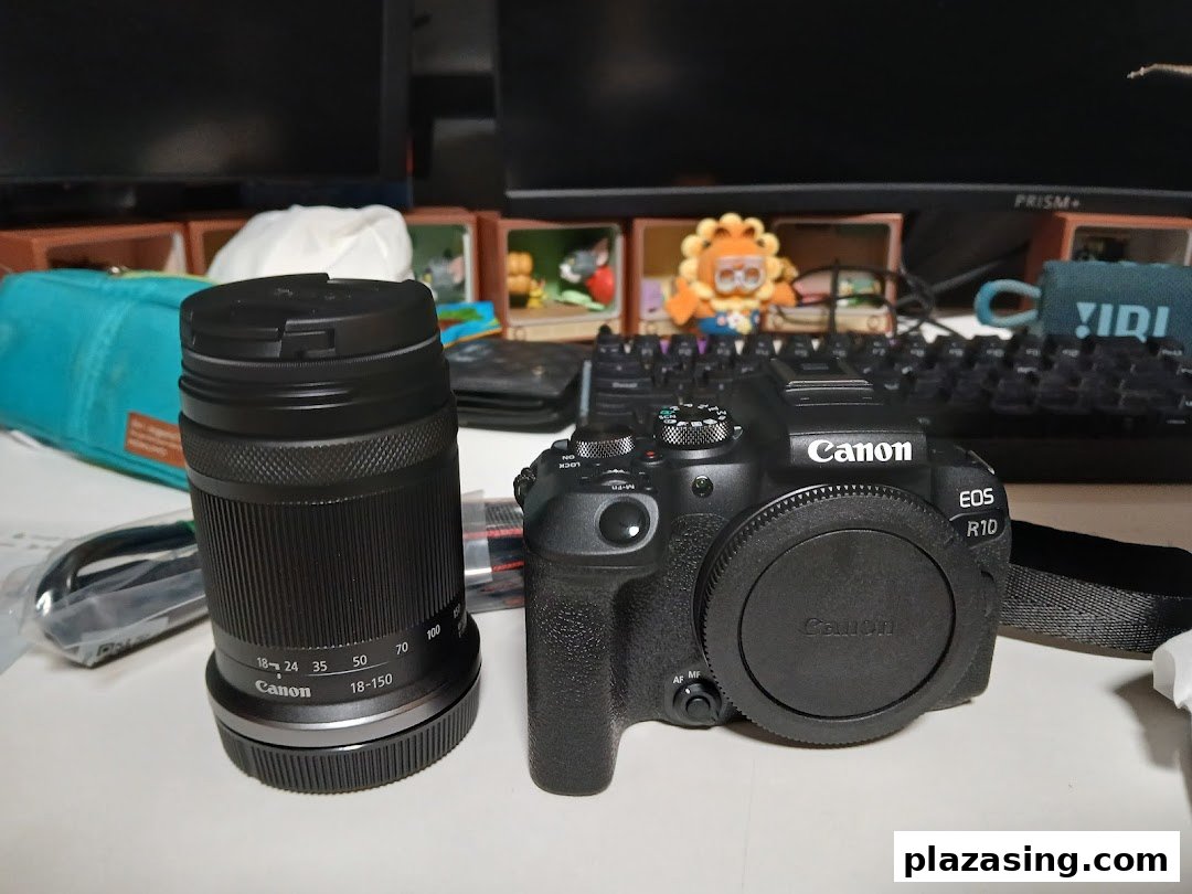 A new Canon EOS R10 camera body and an 18-150mm lens displayed on a desk.