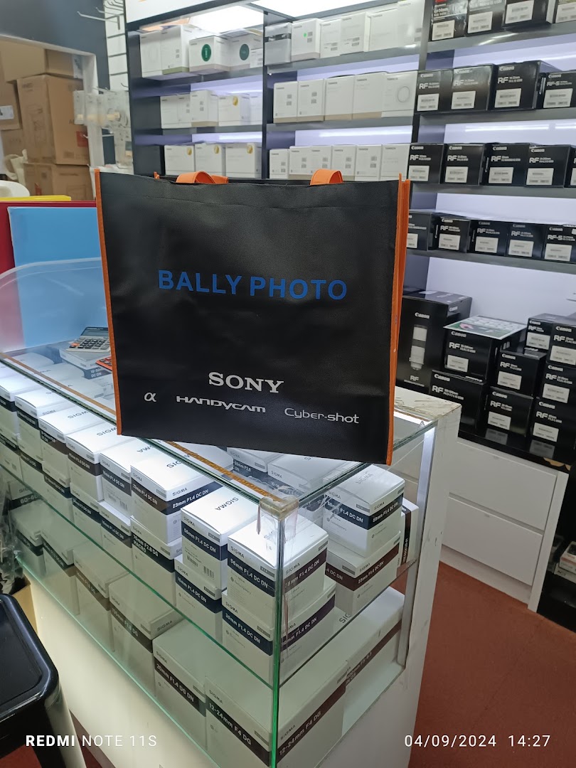Interior view of Bally Photo Electronics, showcasing camera lenses, equipment, and a branded shopping bag.