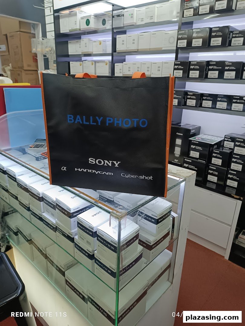 Interior view of Bally Photo Electronics, showcasing camera lenses, equipment, and a branded shopping bag.