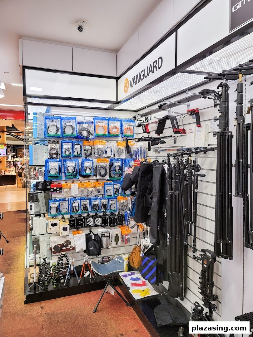 An interior view of Bally Photo Electronics, showcasing camera accessories, tripods, and various electronic gadgets.