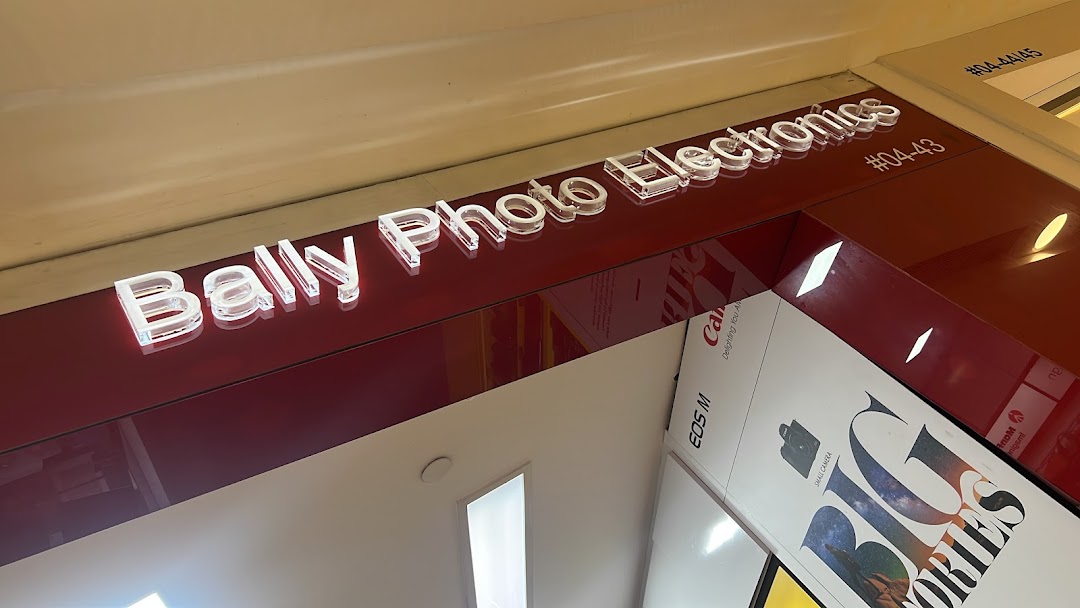 Close-up of Bally Photo Electronics shop front signage and a display featuring cameras.