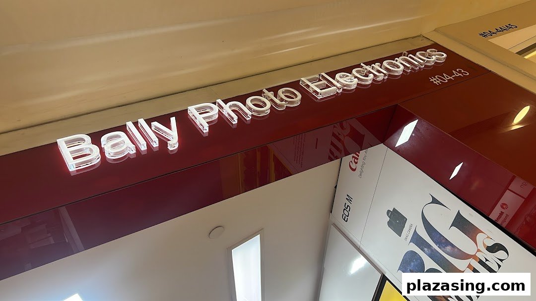 Close-up of Bally Photo Electronics shop front signage and a display featuring cameras.
