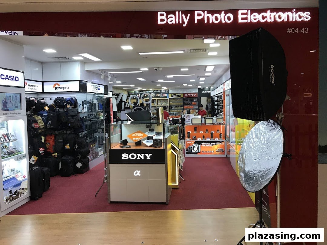 Entrance of Bally Photo Electronics, showcasing cameras, electronics, and photography accessories like bags and lighting.