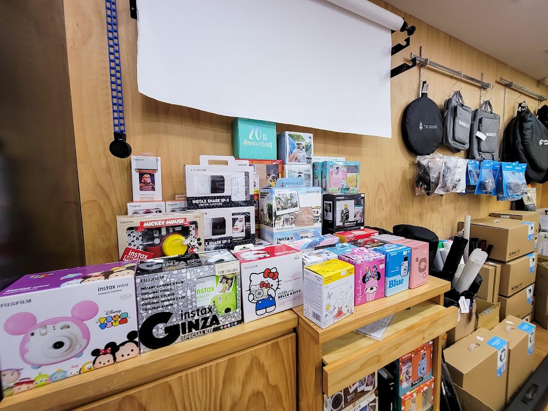 A vibrant display of instant cameras, accessories, and photography gear at Bally Photo Electronics.