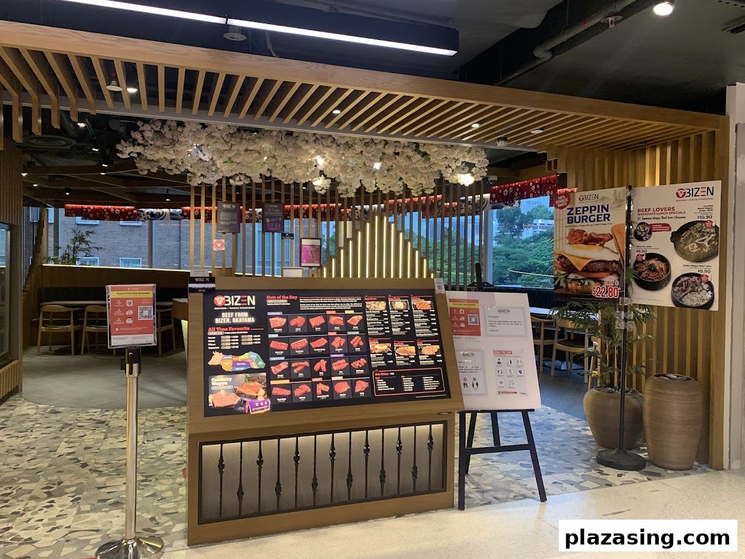 The inviting entrance of Bizen Wagyu Salad Bar, featuring a prominent beef cuts display and promotional posters.
