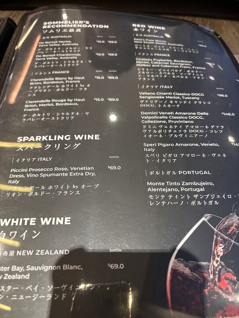 A detailed menu displaying a selection of red, white, and sparkling wines, including sommelier recommendations.