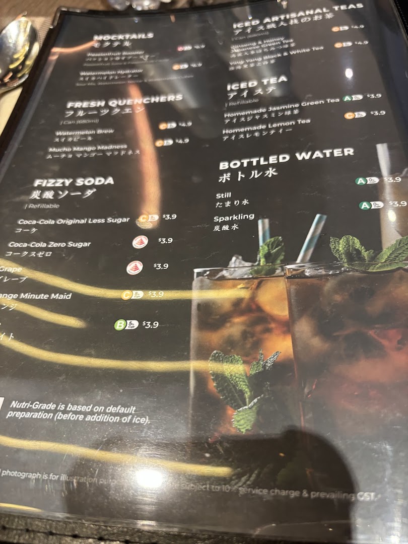A close-up view of a beverage menu featuring various drinks, including sodas, teas, and mocktails.