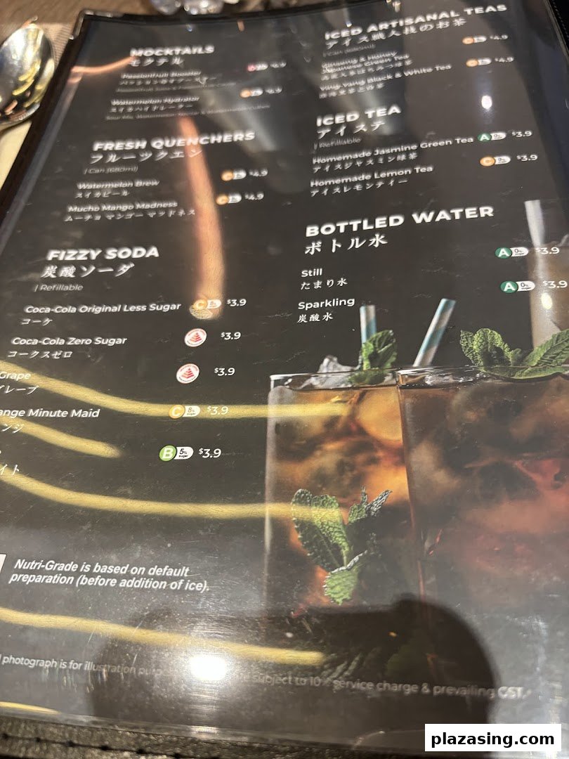 A close-up view of a beverage menu featuring various drinks, including sodas, teas, and mocktails.