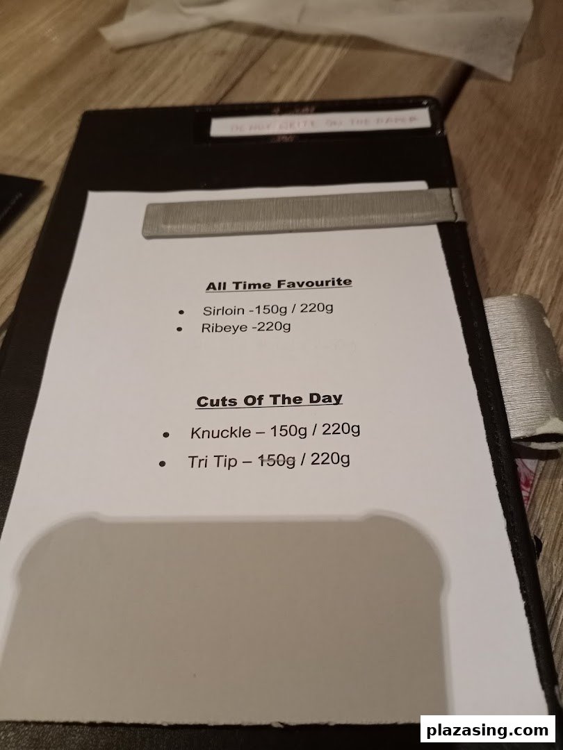 A menu displaying popular steak cuts and daily specials with their respective weights.
