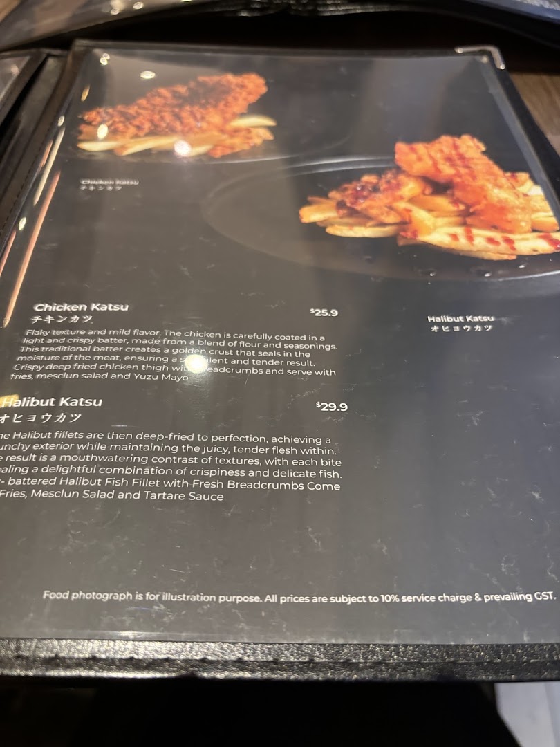 A close-up view of a menu page featuring Chicken Katsu and Halibut Katsu dishes with descriptions and prices.