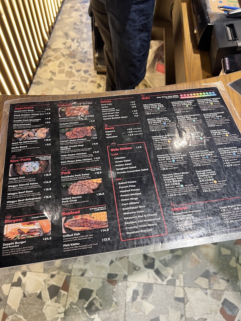 A detailed menu displaying a wide range of Japanese and Western dishes, drinks, and sake.