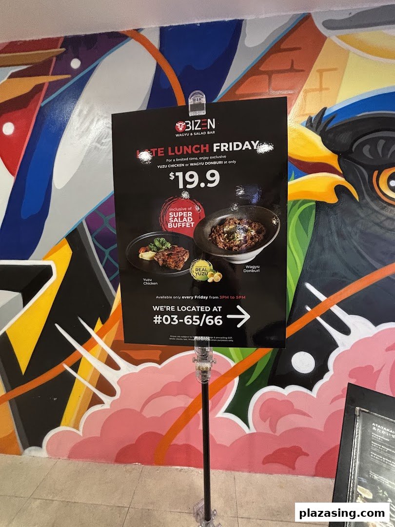 A promotional standee for Bizen Wagyu & Salad Bar's "Late Lunch Friday" offer, featuring Yuzu Chicken and Wagyu Donburi.