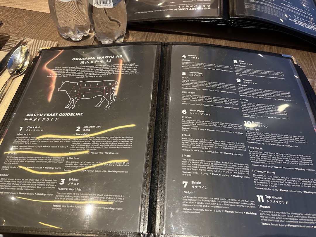 An open menu displaying detailed descriptions of various Okayama Wagyu A3 beef cuts.