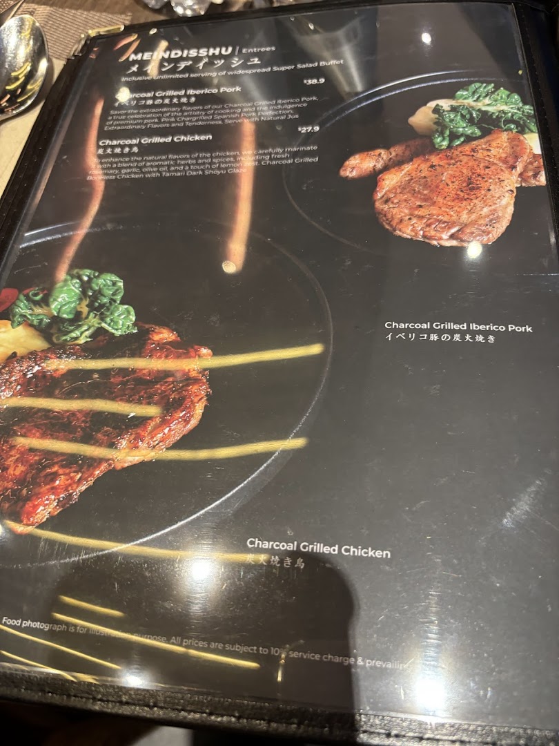 A close-up of a restaurant menu displaying charcoal-grilled pork and chicken entrees with descriptions and prices.