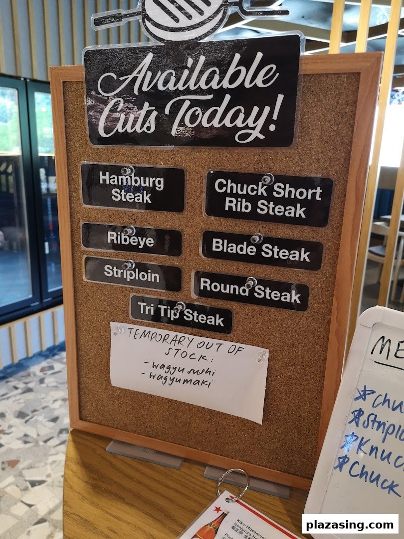 A corkboard display showcasing the available wagyu steak cuts for the day at Bizen Wagyu Salad Bar.