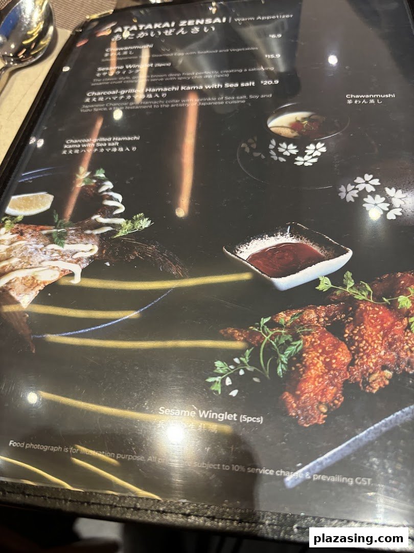 A close-up view of a menu page featuring Japanese warm appetizers with descriptions and prices.