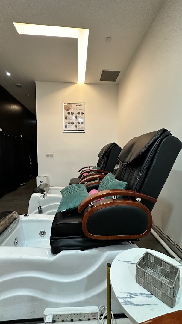 Comfortable pedicure chairs with foot baths in a well-lit spa setting.