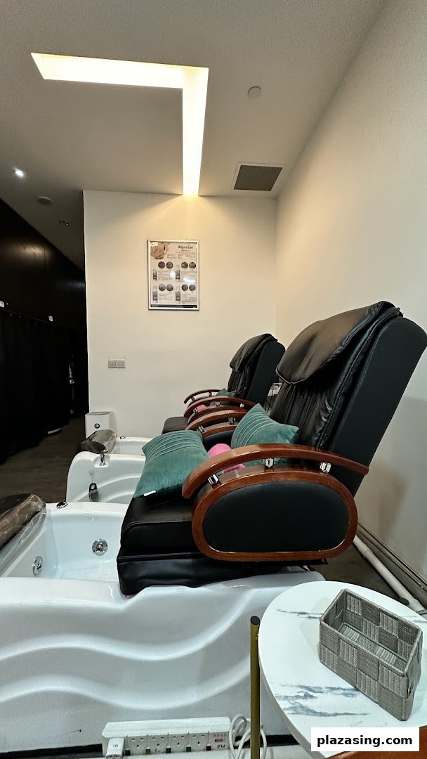 Comfortable pedicure chairs with foot baths in a well-lit spa setting.