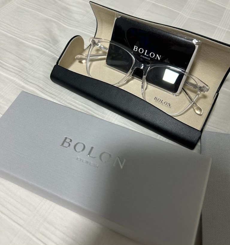 Bolon Eyewear glasses, case, and box, showcasing the brand's clear frame design.
