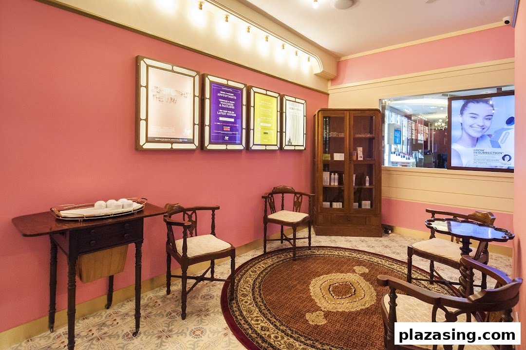 A cozy, pink-walled waiting area with vintage furniture and promotional displays at Browhaus.