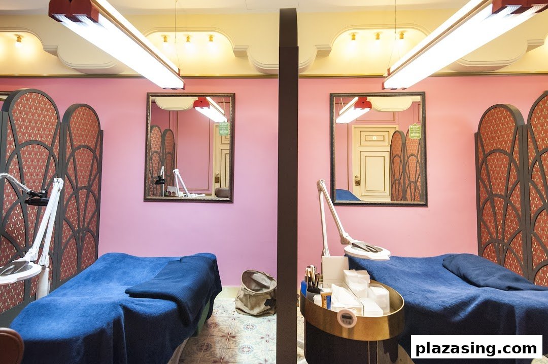 Two vibrant pink treatment rooms with blue beds, ornate screens, and beauty equipment at Browhaus.