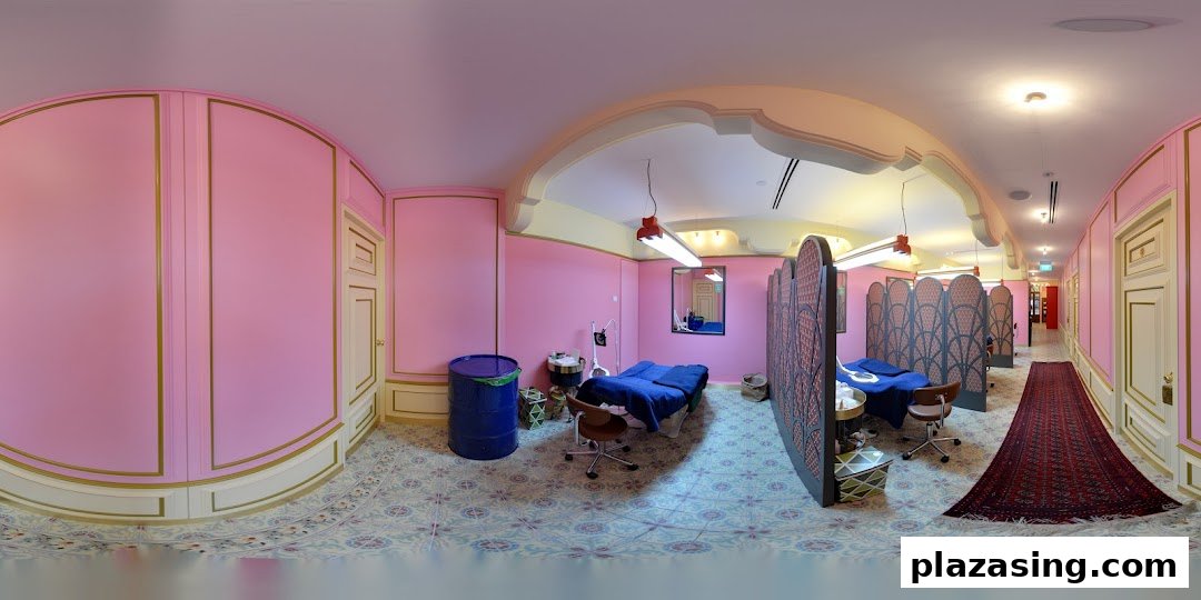 A vibrant pink and gold interior of Browhaus, featuring treatment beds, privacy screens, and a hallway.