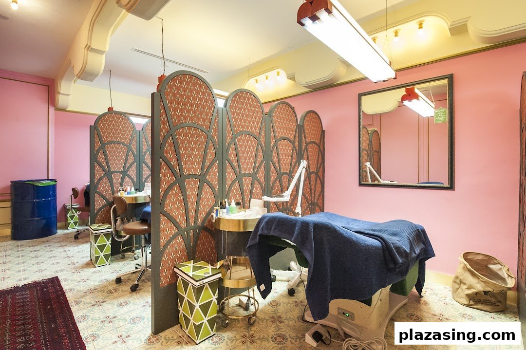 Interior view of Browhaus, featuring pink walls, decorative screens, and multiple beauty treatment stations.