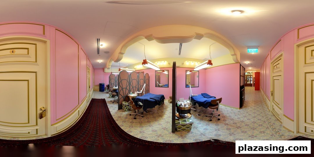 A vibrant pink and gold interior of Browhaus, featuring multiple treatment stations with beds and beauty equipment.