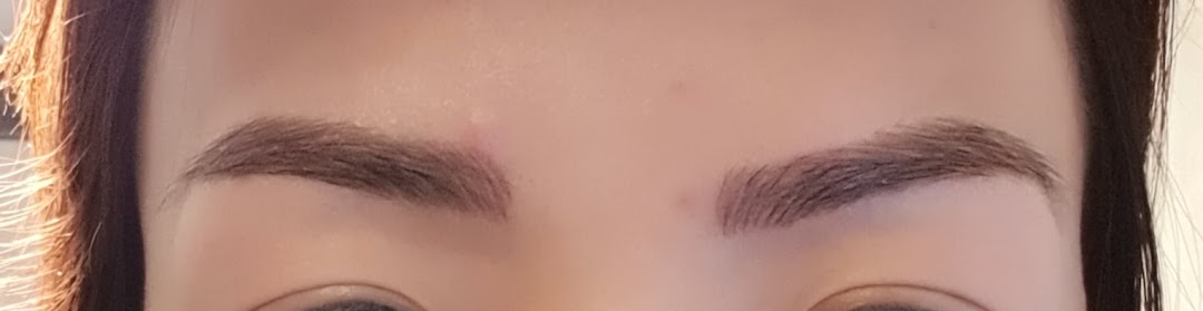 Close-up of a person's face showcasing perfectly groomed and defined eyebrows.