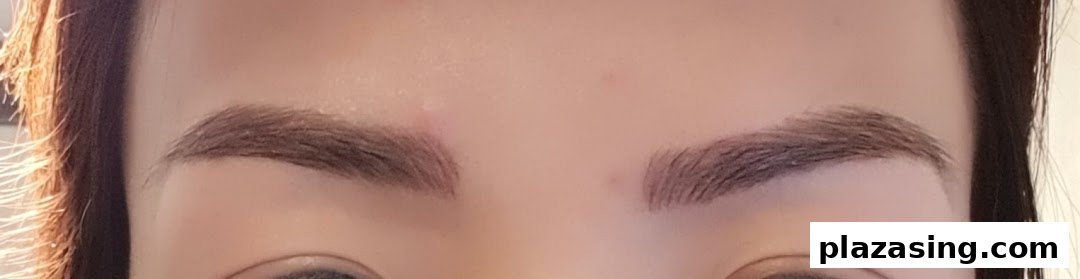 Close-up of a person's face showcasing perfectly groomed and defined eyebrows.