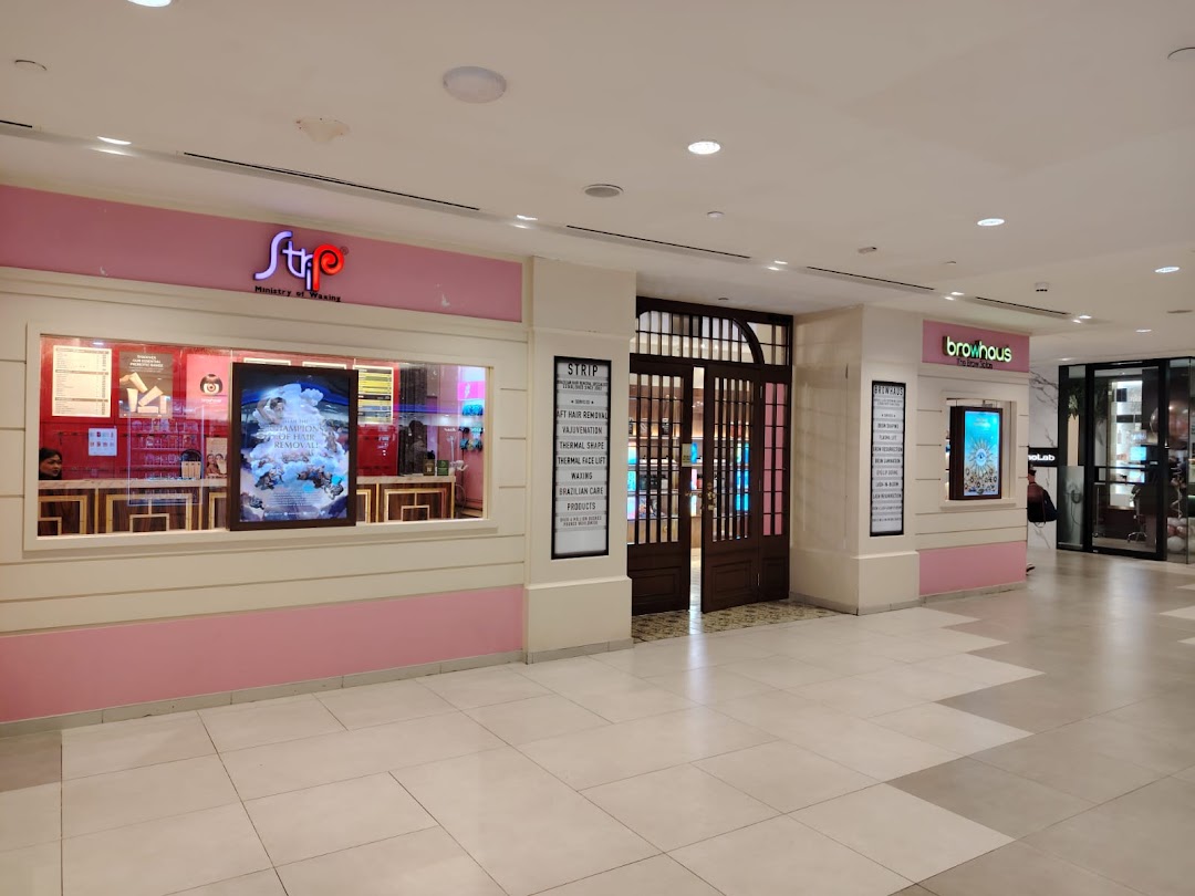 The inviting storefronts of Browhaus and Strip Ministry of Waxing in a modern shopping mall.