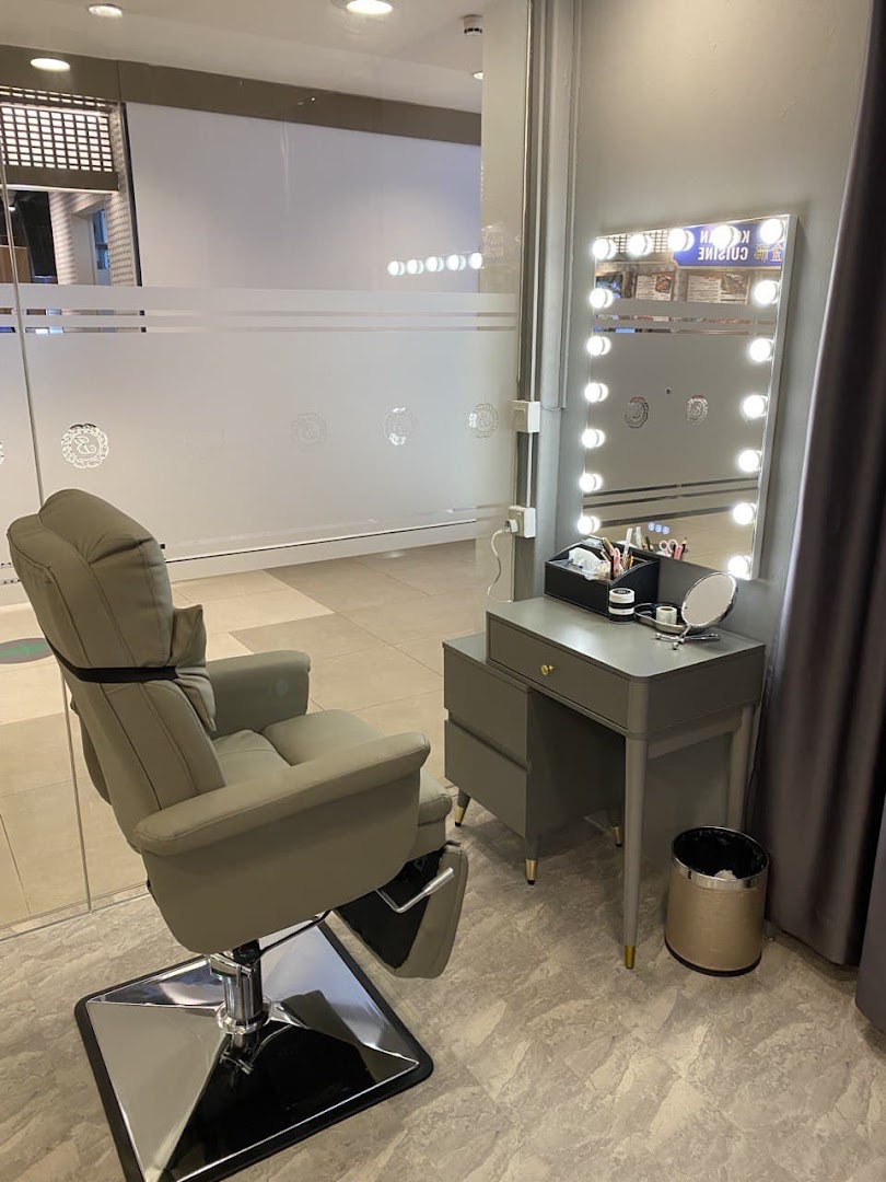 An inviting interior shot of Browtisan, featuring a comfortable treatment chair and a well-lit vanity station.