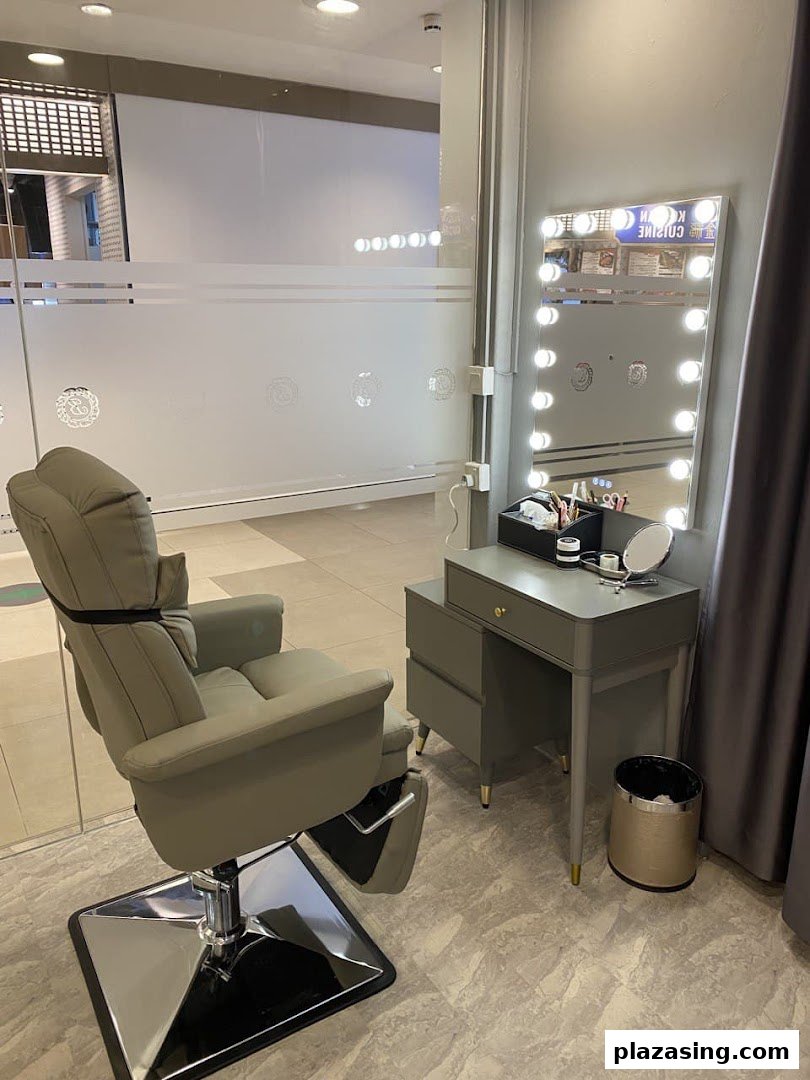 An inviting interior shot of Browtisan, featuring a comfortable treatment chair and a well-lit vanity station.