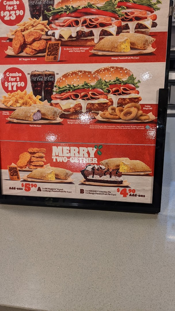 A vibrant Burger King menu board showcasing various combo meals and add-ons.
