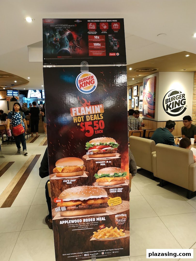 A promotional stand inside Burger King Plaza Singapura showcasing 'Flamin' Hot Deals' and Halloween prizes.